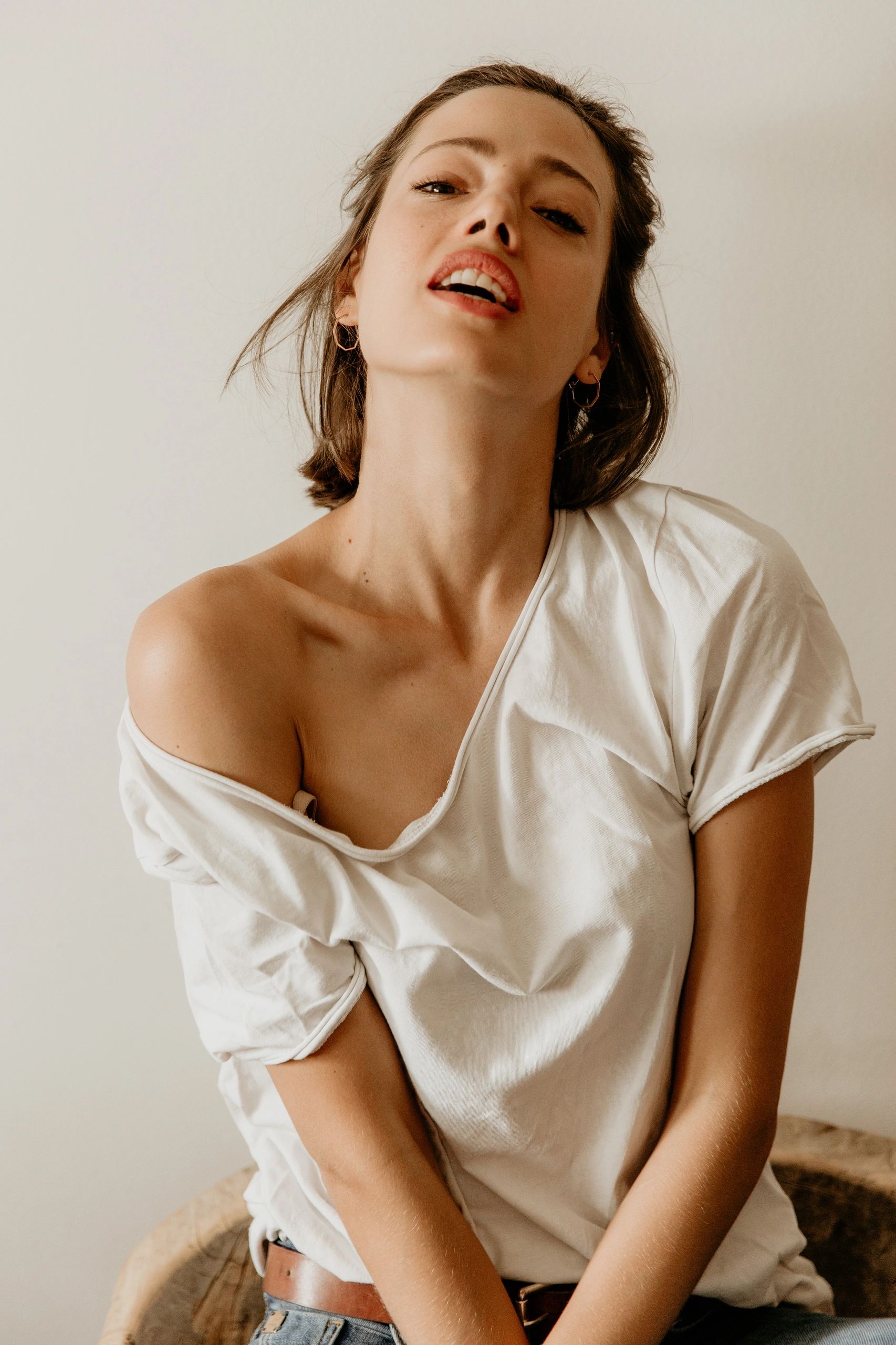 Playful close-up portrait of woman in white top