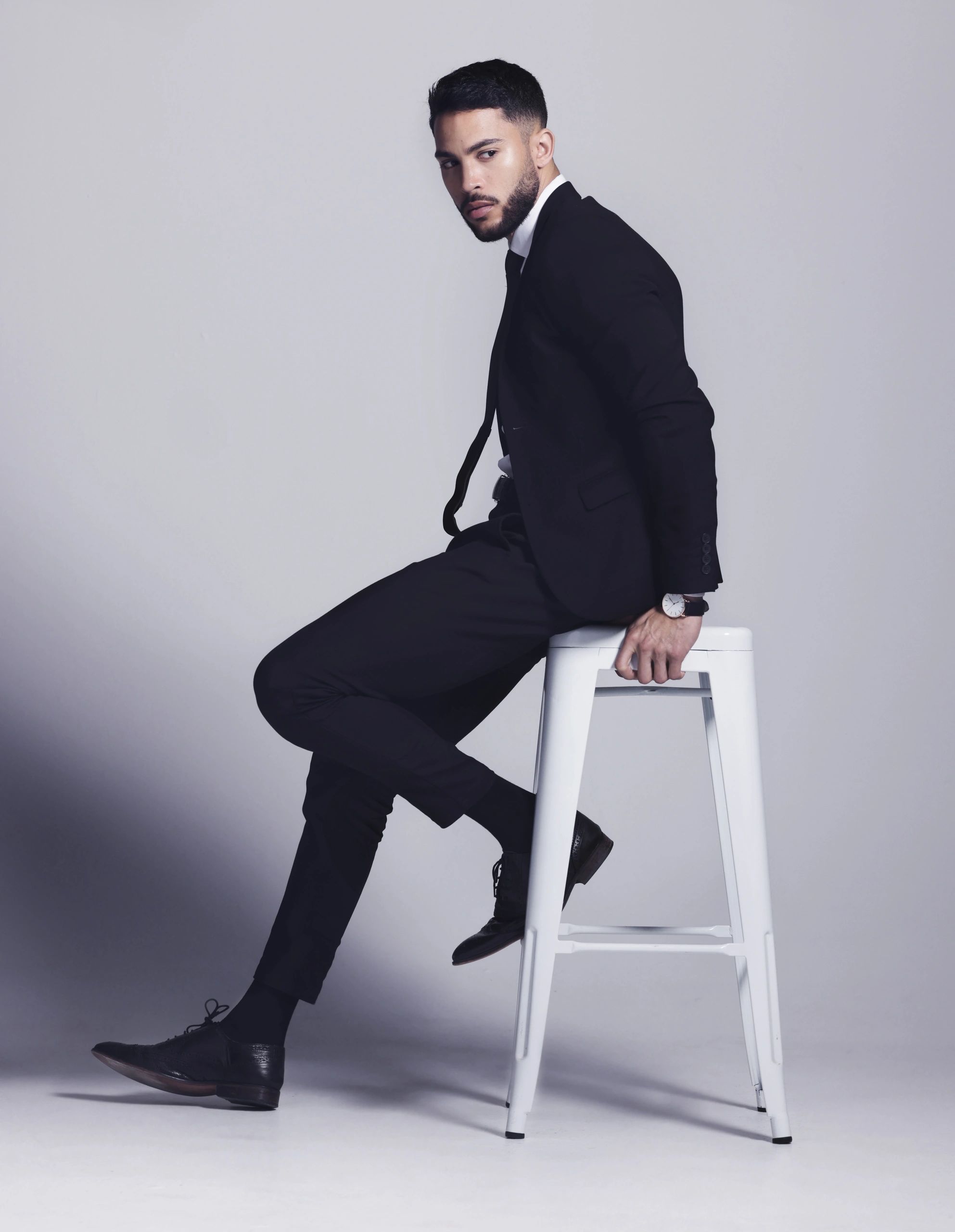 Young man posing in studio against gray background