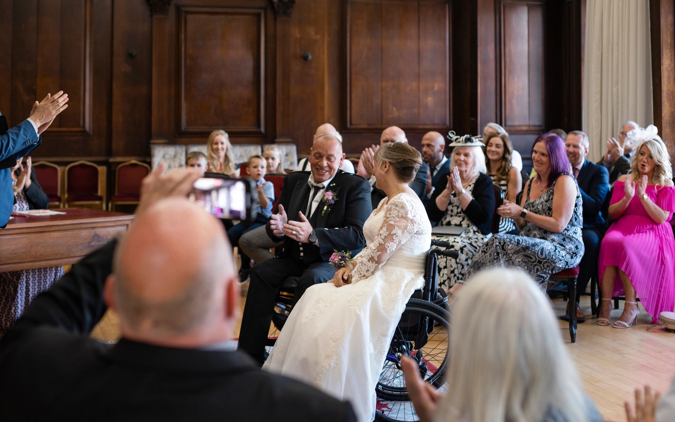 Wedding guests applauding after the ceremony