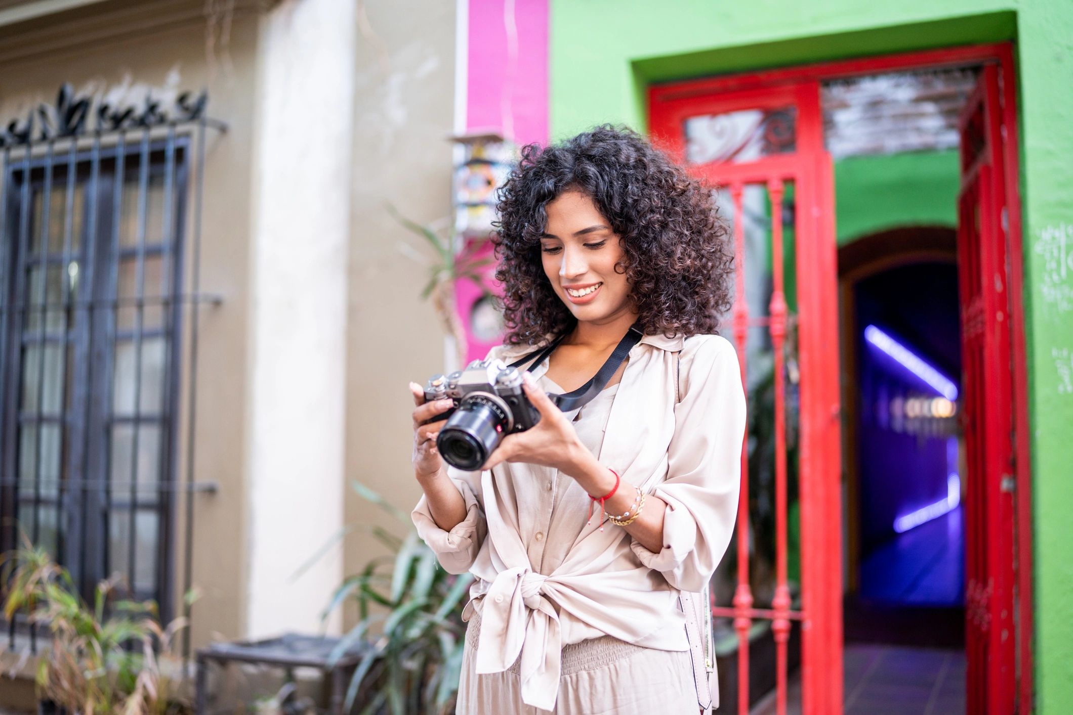 Photographer reviewing images on a camera outdoors