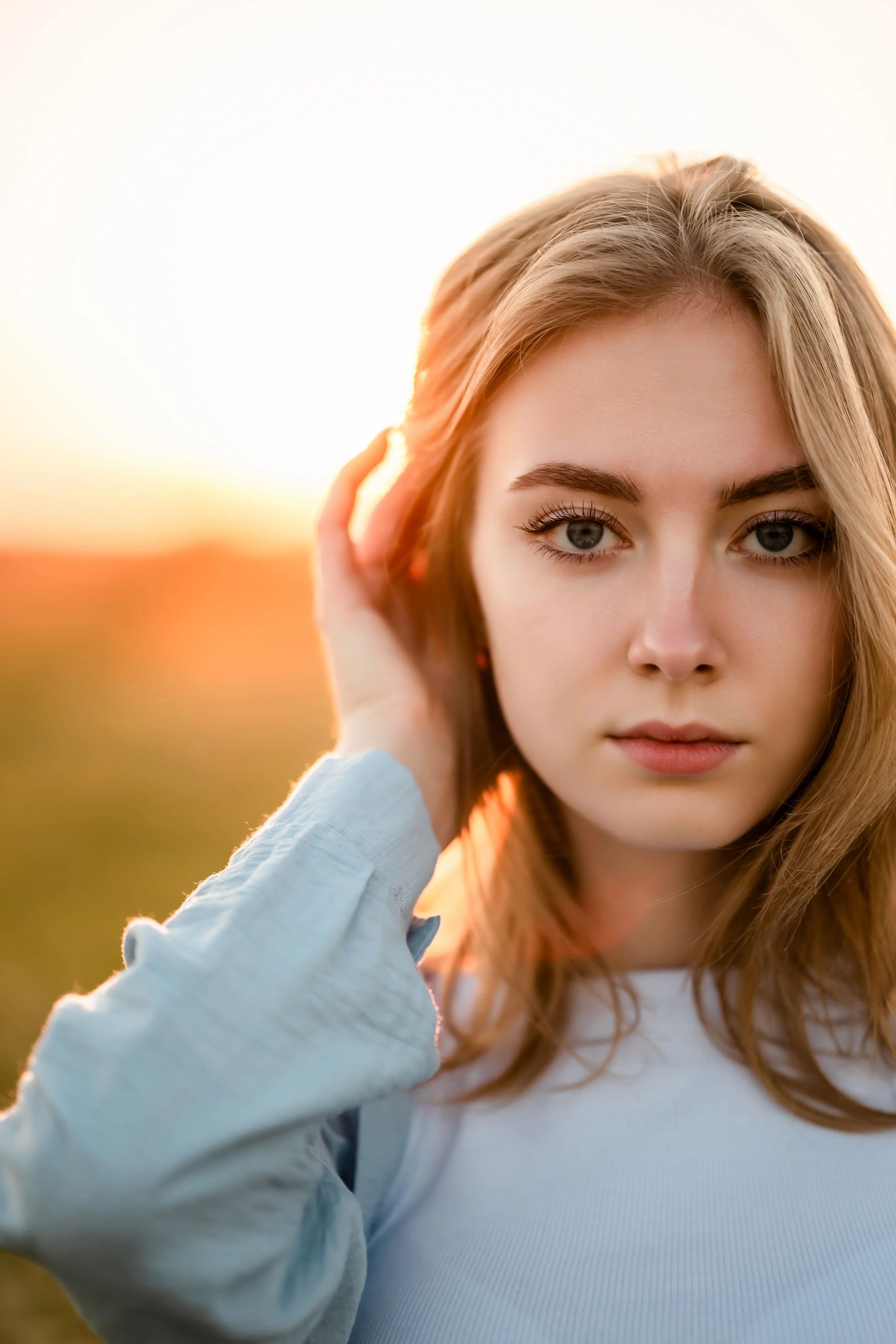 Woman in field at sunset