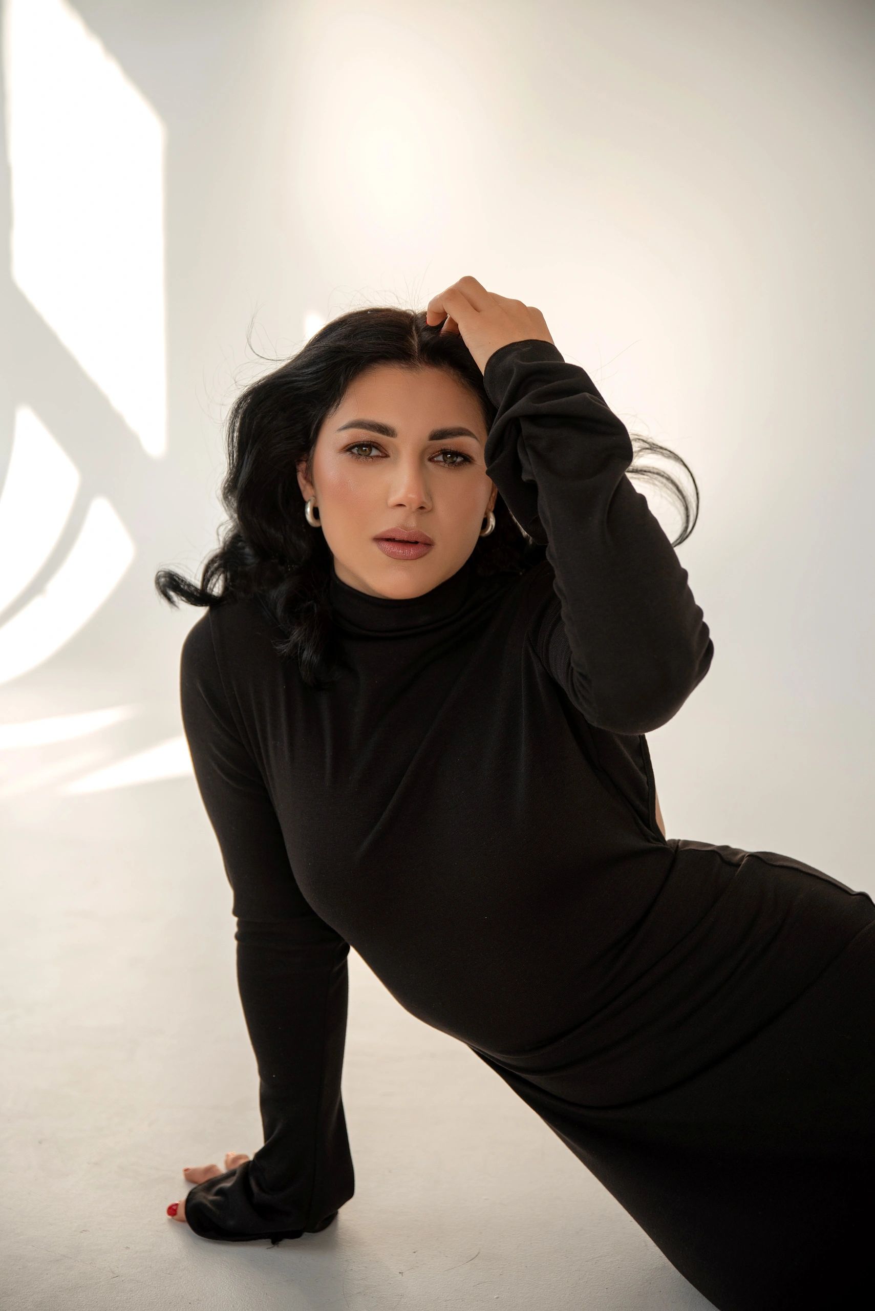 Model in black dress photographed in studio