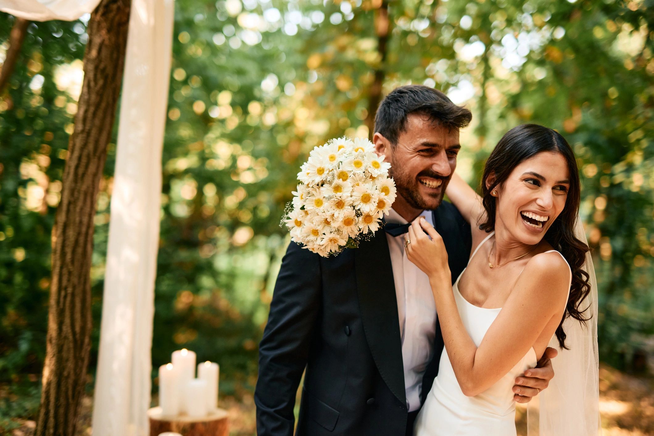 Newlyweds smiling together in the woods