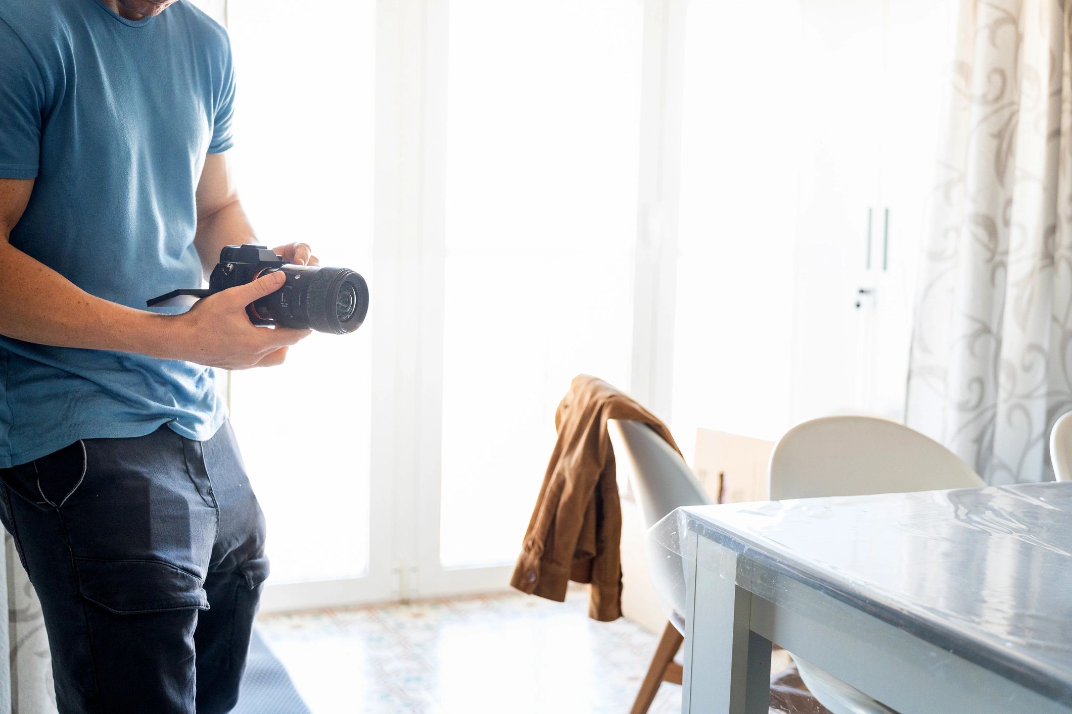 Photographer adjusting camera settings during a shoot