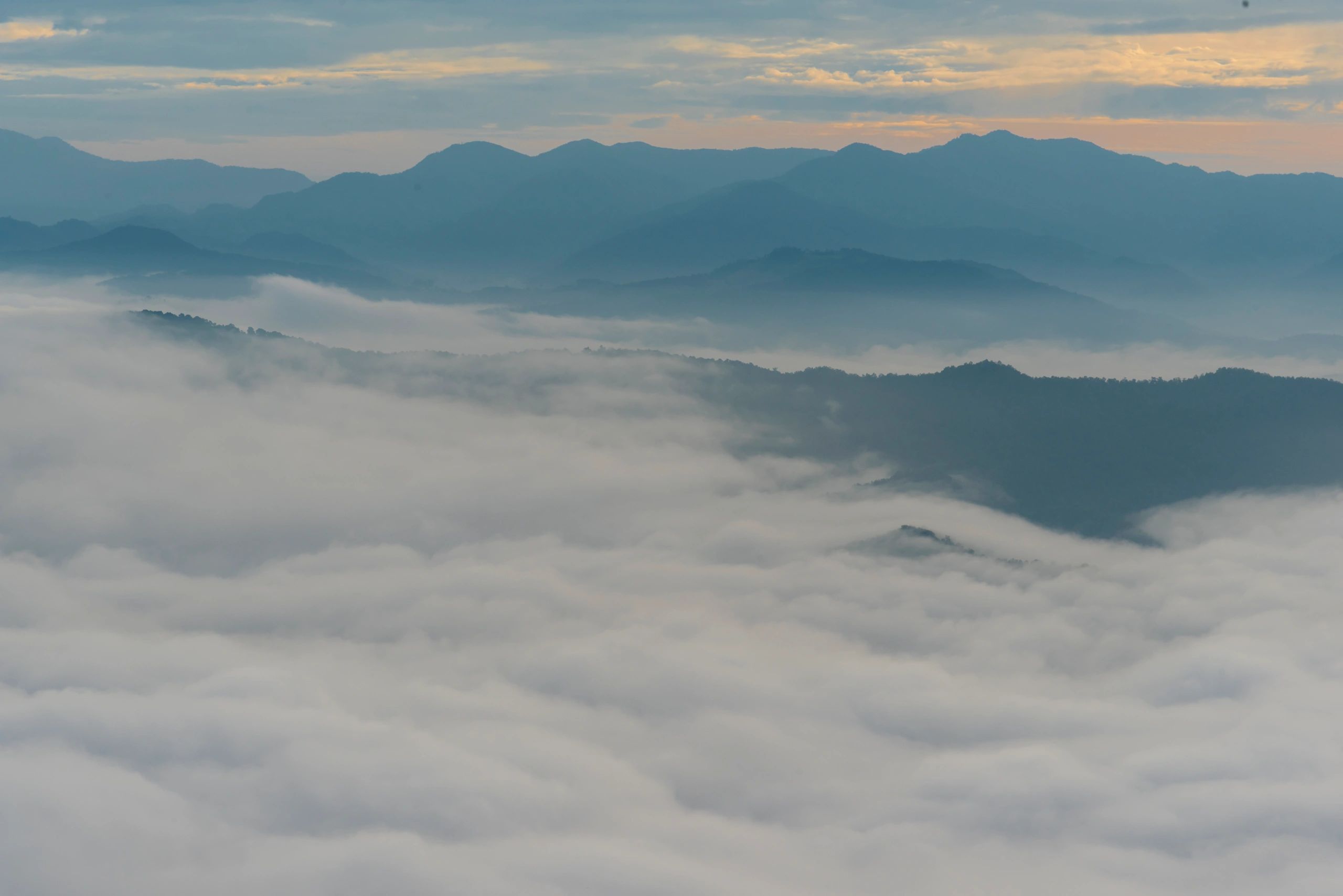 Misty mountain landscape with dense fog